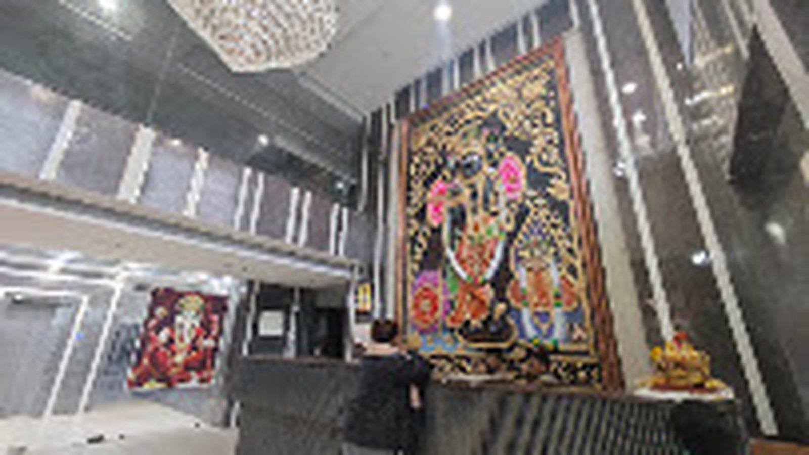 Reception lobby with chandelier and religious artwork at Shri Shiv Krishna Dham, Vrindavan